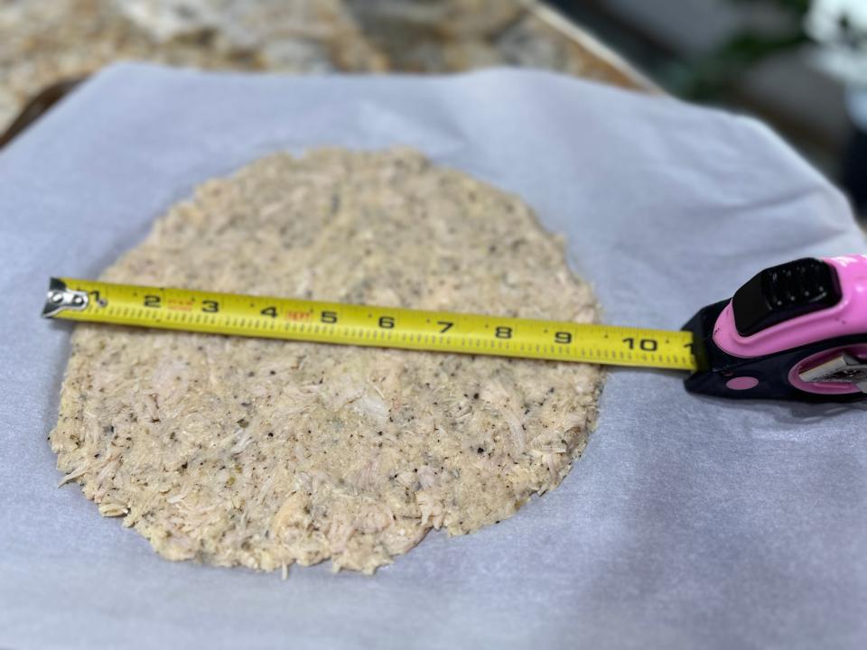 Measuring tape measuring chicken pizza crust to be over 9 inches in diameter 