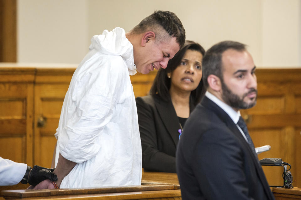 Victor Pena, left, is arraigned on kidnapping charges at the Charlestown Division of the Boston Municipal Court in Charlestown, Mass., Wednesday, Jan. 23, 2019. Pena's defense attorney Joseph Perullo, right, and an interpreter stand by his side. Pena, who has been charged with kidnapping a 23-year-old woman in Boston has been ordered to undergo a mental health evaluation and will be held without bail. (Aram Boghosian/The Boston Globe via AP, Pool)