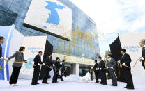 FILE - In this Sept. 14, 2018 file photo, South Korea's Unification Minister Cho Myoung-gyon, center left, and Ri Son Gwon, chairman of the North's Committee for the Peaceful Reunification, center right, attend at an opening ceremony for two Koreas' first liaison office in Kaesong, North Korea. North Korea has threatened to end an inter-Korean military agreement reached in 2018 to reduce tensions if the South fails to prevent activists from flying anti-Pyongyang leaflets over the border. Kim Yo Jong, the powerful sister of North Korean leader Kim Jong Un, said Thursday, June 4, 2020, the North could permanently shut a liaison office with the South and an inter-Korean factory park in the border town of Kaesong, which have been major symbols of reconciliation between the rivals. (Korea Pool/Yonhap via AP, File)