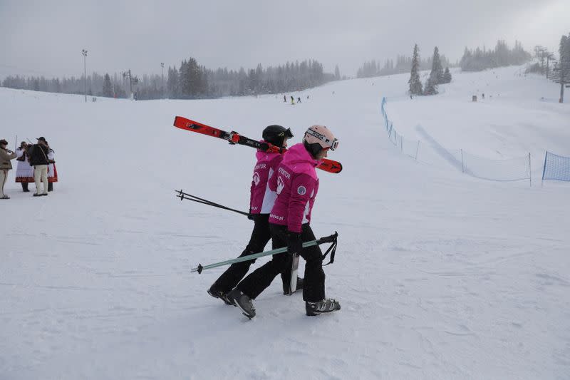 Skiers hold skis as they enjoy first day after loosening coronavirus disease (COVID-19) restrictions at ski slope in Jurgow