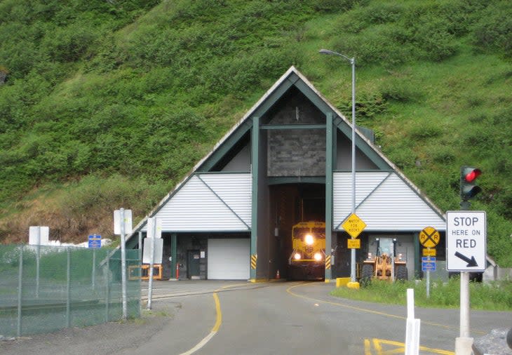 A train arrives at the Portage Glacier entrance to the one-way Anton Anderson Memorial Tunnel