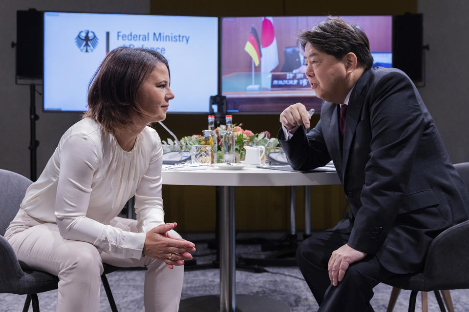 Germany's Foreign Minister Annalena Baerbock, right, and Japan's Foreign Minister, Yoshimasa Hayashi, left, talk during a G7 Foreign Ministers meeting in Muenster, Germany, Thursday, Nov. 3, 2022. (Rolf Vennenbernd/dpa via AP, Pool)