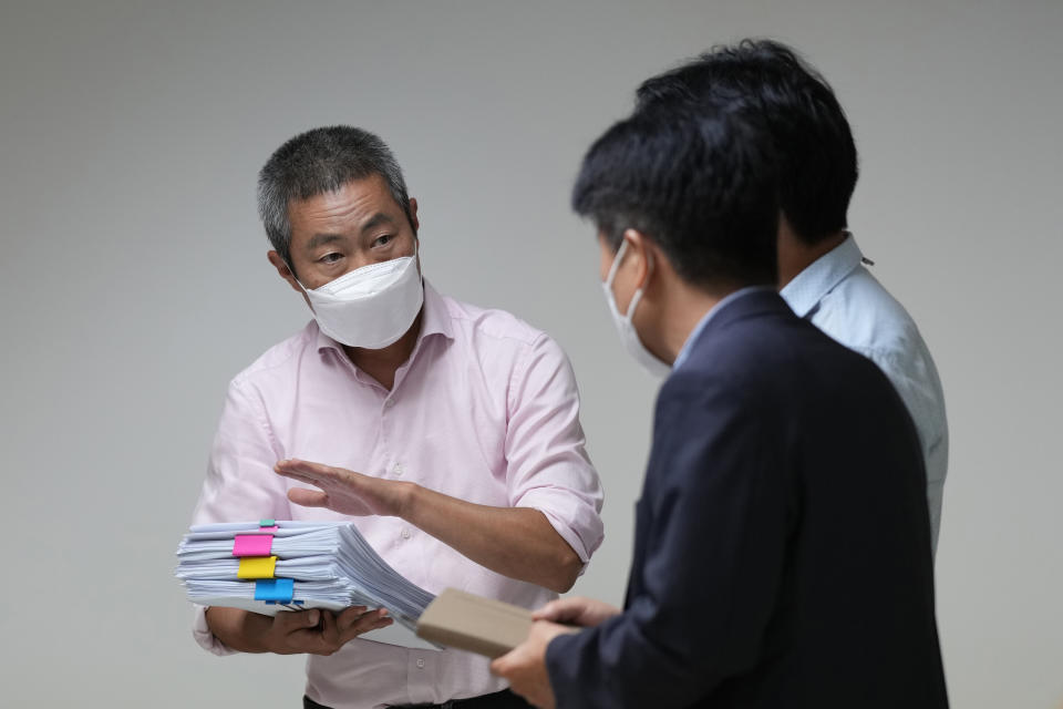 Peter Møller, attorney and co-head of the Danish Korean Rights Group, speaks as he holds documents at the Truth and Reconciliation Commission in Seoul, South Korea, Tuesday, Aug. 23, 2022. Dozens of South Korean adoptees who were sent to Danish parents as children in the 1970s and ‘80s have formally demanded Tuesday, Aug 23, 2022, the South Korean government investigate the circumstances surrounding their adoptions, which they say were corrupted by systemic practices that falsified or obscured children's origins. (AP Photo/Lee Jin-man)