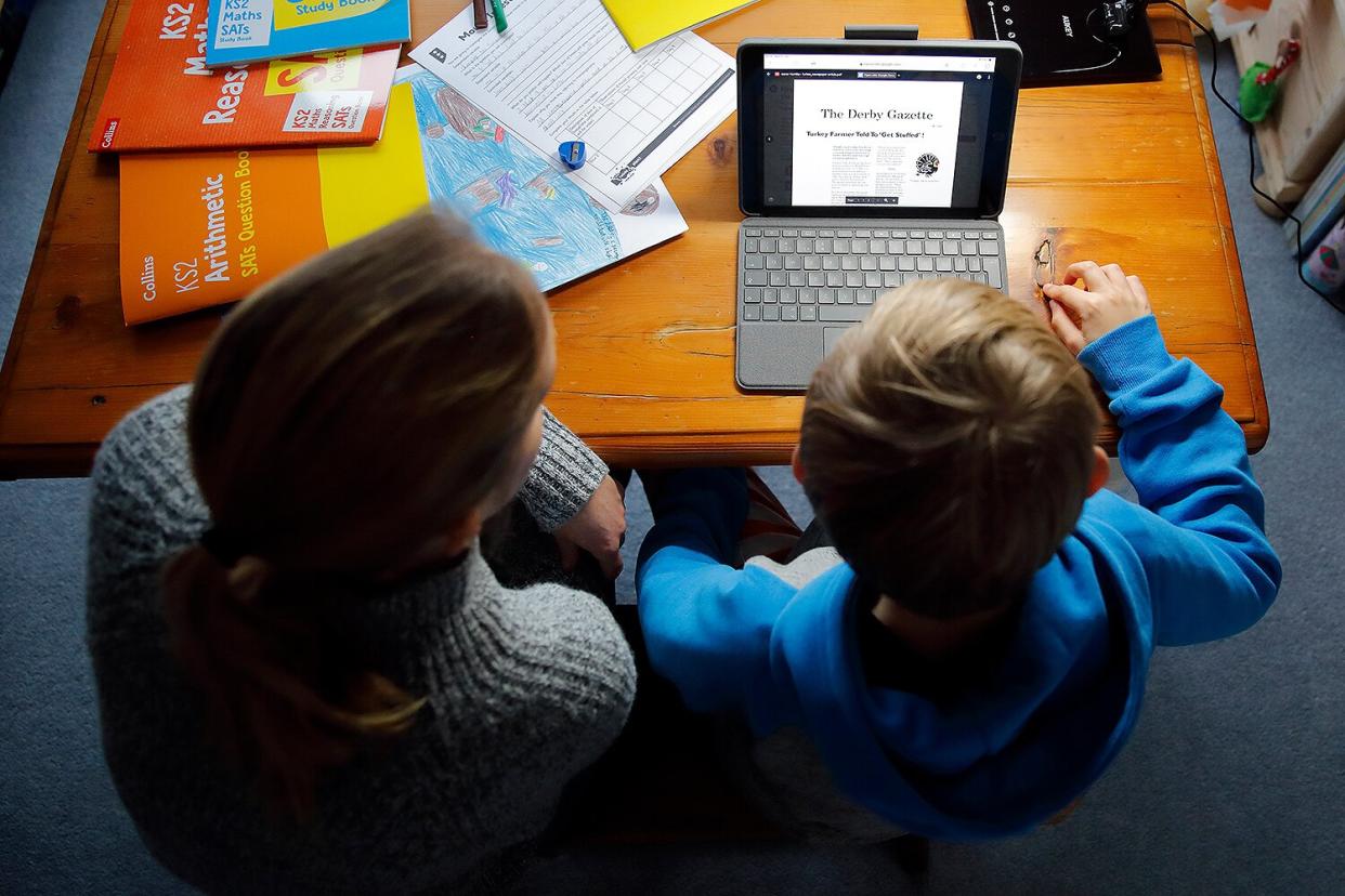 parent and child doing schoolwork