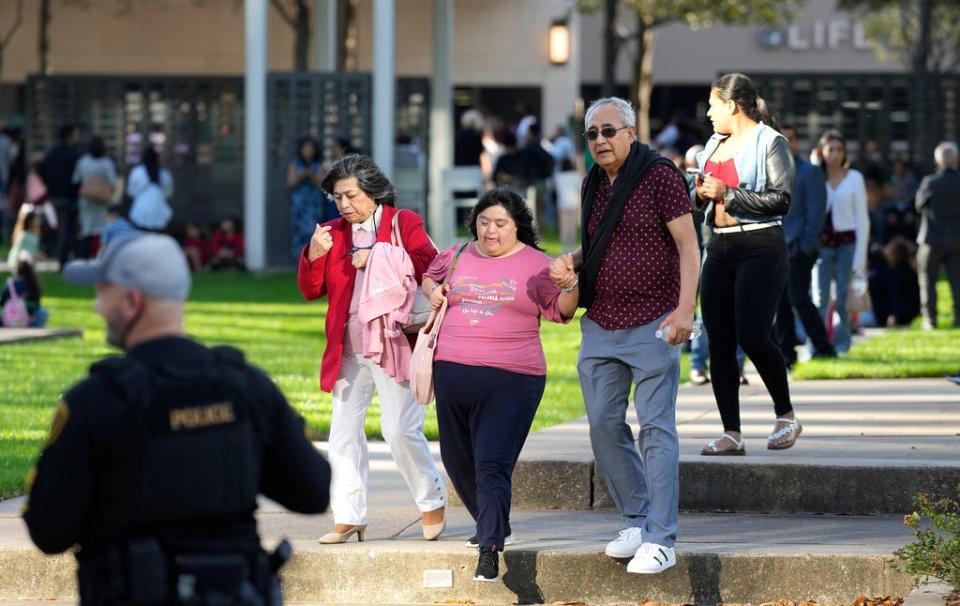 Houston Police officers watch over displaced churchgoers outside Lakewood Church, Sunday, Feb. 11, 2024, in Houston, after a reported shooting during a Spanish church service.