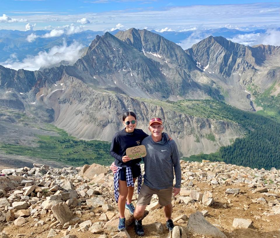 Oanh Hoang and Joe Ramsey stand on the summit of Huron Peak in Colorado on July 30, 2022.