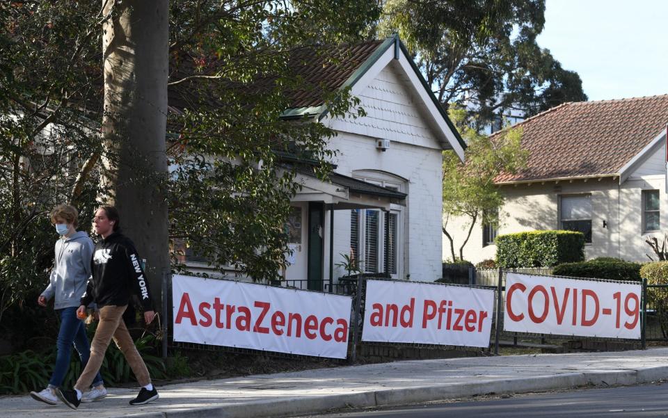 Signs advertising the coronavirus vaccine in Lane Cove, a suburb of Sydney - James D Morgan/Getty Images