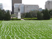 White flags, placed by Gov. John Bel Edwards' office and representing every Louisiana death from COVID-19, are displayed outside the state Capitol, Tuesday, March 9, 2021, are near the statue of former Gov. Huey Long in Baton Rouge, La. (AP Photo/Melinda Deslatte) Slug BC-LA--Virus Outbreak-Louisiana Gov. John Bel Edwards' office placed