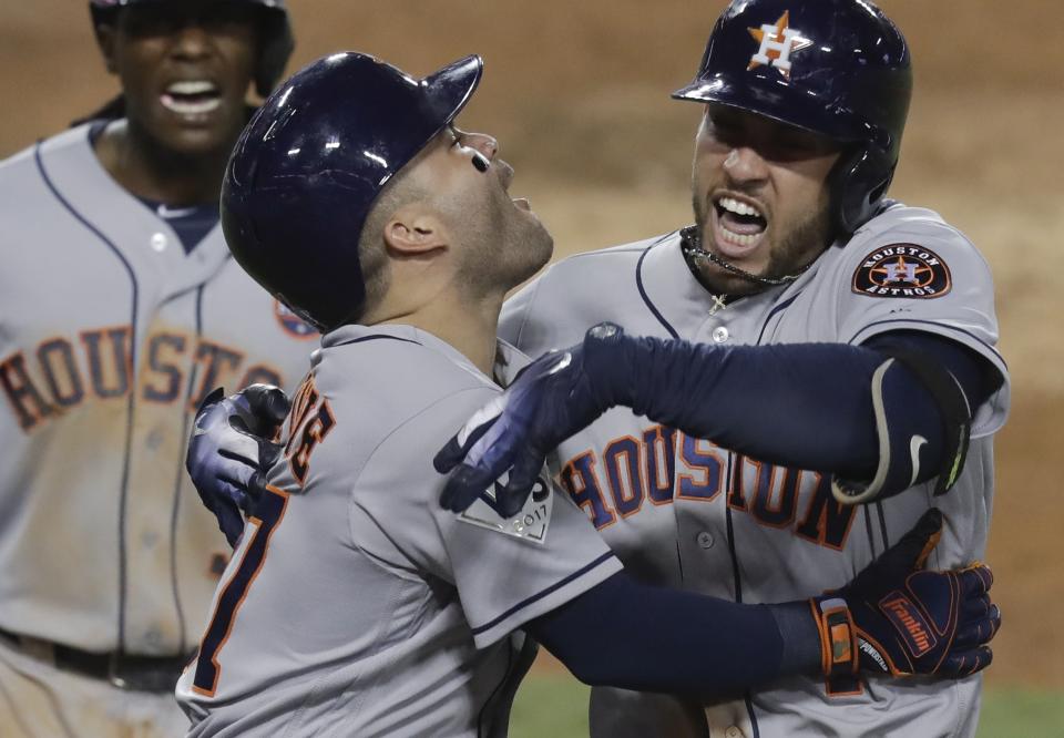 George Springer, right, celebrates with Jose Altuve after hitting a two-run home run during the 11th inning of Game 2 of the World Series. (AP)