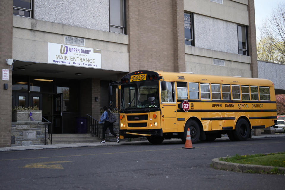 A student arrives for class at Upper Darby High School, Wednesday, April 12, 2023, in Drexel Hill, Pa. For some schools, the pandemic allowed experimentation to try new schedules. Large school systems including Denver, Philadelphia and Anchorage, Alaska, have been looking into later start times. (AP Photo/Matt Slocum)