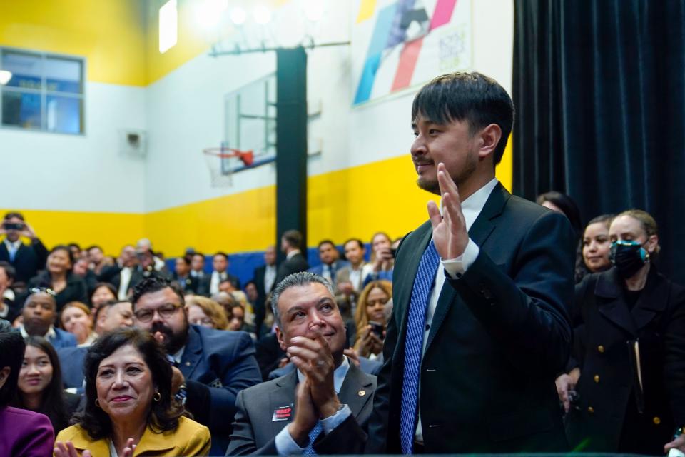 Brandon Tsay stands and waves as President Joe Biden speaks on efforts to reduce gun violence at The Boys & Girls Club of West San Gabriel Valley on Tuesday in Monterey Park, Calif.