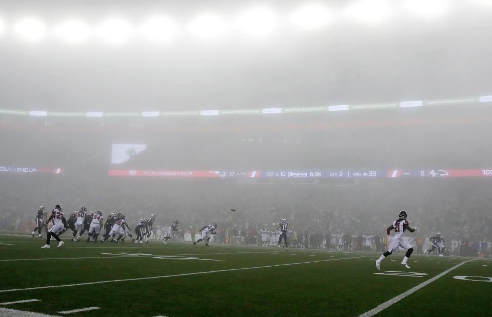 <p>New England Patriots wide receiver Chris Hogan, center, catches a pass as fog settles over the field during the second half of an NFL football game against the Atlanta Falcons, Sunday, Oct. 22, 2017, in Foxborough, Mass. (AP Photo/Charles Krupa) </p>