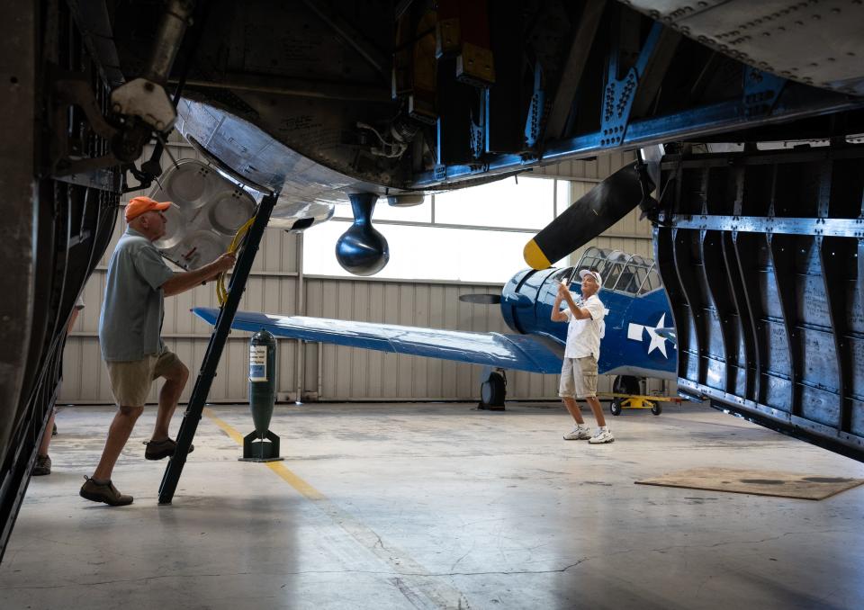 Visitors tour and photograph a B-17, Oct. 12, 2022, in the maintenance and restoration hanger at the Arizona Commemorative Air Force Museum, 2017 N. Greenfield Road, Mesa, Ariz.