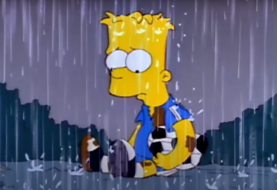 Bart Simpson sits alone, drenched in rain, looking sad and holding a soccer ball