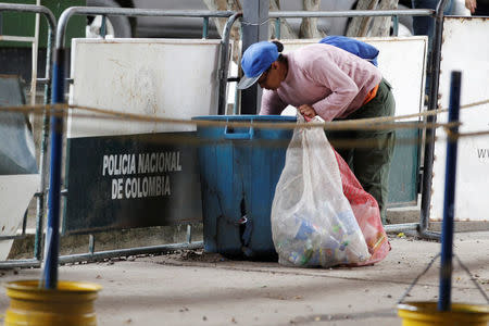 A woman searches through garbage at the Simon Bolivar International Bridge in Cucuta, Colombia August 8, 2018. REUTERS/Luisa Gonzalez