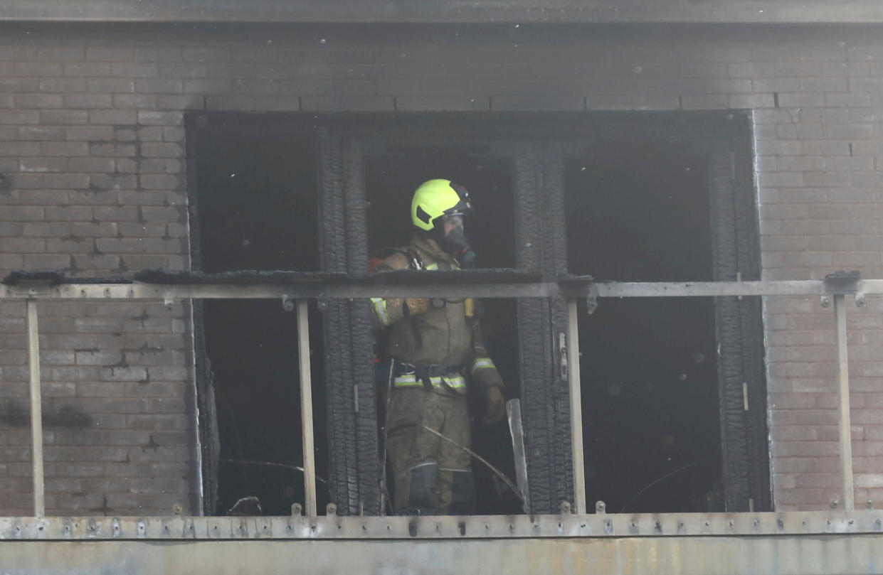 Firefighter attends to a building after a fire broke out in Barking, London, Britain, June 9, 2019. REUTERS/Simon Dawson