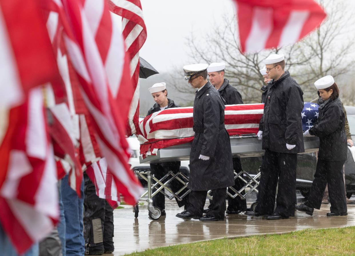 A U.S. Navy funeral detail escorts the casket of Fireman 1st Class Walter Schleiter to the site of his military funeral Thursday at the National Cemeteries of the Alleghanies in Bridgeville, Pennsylvania.