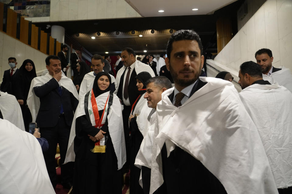 FILE - Lawmakers belonging to Iraqi cleric Muqtada al-Sadr's parliamentary bloc prepare to attend a parliamentary session in Baghdad, Iraq, Saturday, March 26, 2022. More than seven months after national elections, Iraq still doesn't have a government. Driven by cutthroat competition for power and resources between elites, there is no clear way out of the unprecedented impasse. (AP Photo/Hadi Mizban, File)