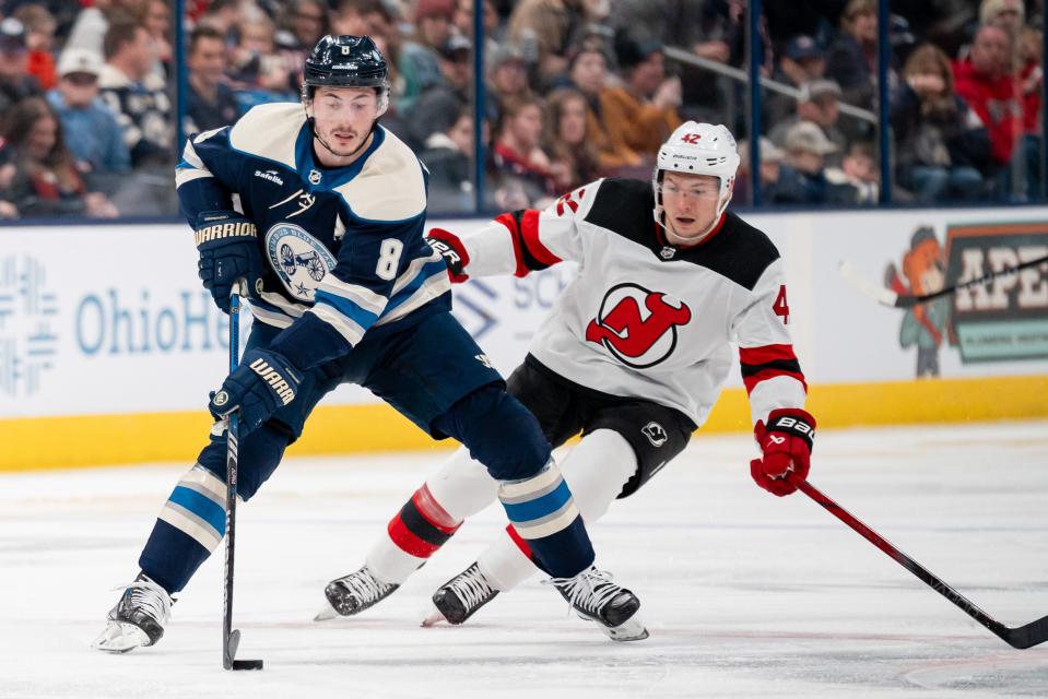 Dec 16, 2023; Columbus, Ohio, USA;
Columbus Blue Jackets defenseman Zach Werenski (8) looks for an open pass around New Jersey Devils center Curtis Lazar (42) during the third period of their game on Saturday, Dec. 16, 2023 at Nationwide Arena.