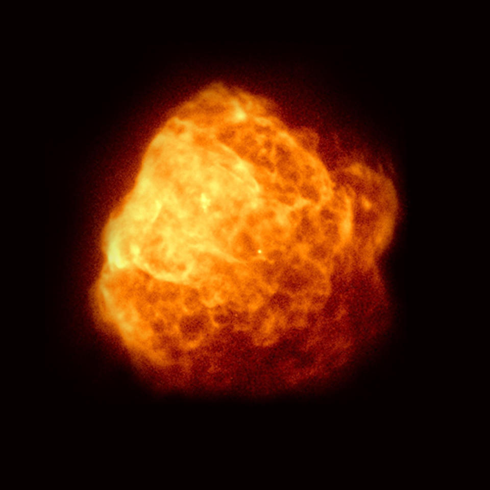 A view of a yellow and orange, slightly blurry cloud in space.