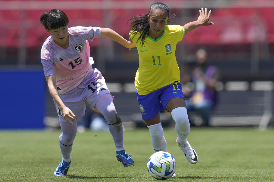 Brazil's Adriana, right, and Japan's Aoba Fujino battle for the ball during a women's friendly soccer match at Morumbi stadium in Sao Paulo, Brazil, Sunday, Dec. 3, 2023. (AP Photo/Andre Penner)