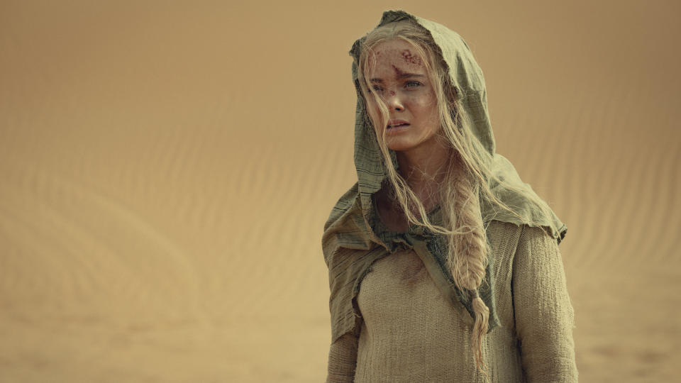 A hooded Ciri stands in the Korath Desert in The Witcher season 3 volume 2