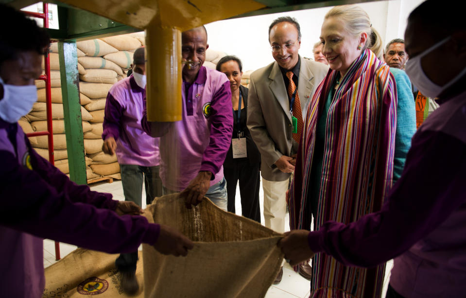 U.S. Secretary of State Hillary Rodham Clinton, 2nd right, watches coffee beans come out of a sorter during a tour of the Timor Coffee Cooperative in Dili, East Timor Thursday, Sept. 6, 2012. U.S. Secretary of State Hillary Rodham Clinton is in East Timor to offer the small half-island nation support as it ends its reliance on international peacekeepers. (AP Photo/Jim Watson, Pool)