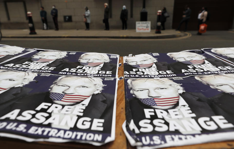 People queue at the entrance of the Old Bailey court in London, Monday, Sept. 21, 2020, as the Julian Assange extradition hearing to the US continues. (AP Photo/Frank Augstein)