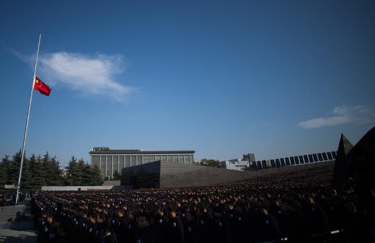 People attend a memorial ceremony on China's first National Memorial Day for Nanjing Massacre Victims in Nanjing city on December 13, 2014