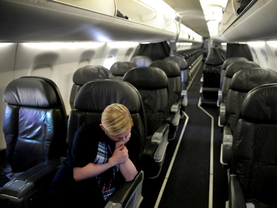 A woman flight attendant in a Delta uniform waits for the departure of a one-passenger flight between Washington and New Orleans