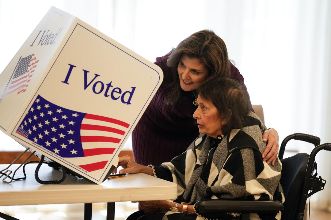 Nikki Haley helps her mother Raj Kaur Randhawa to the voting booth on Feb. 24.