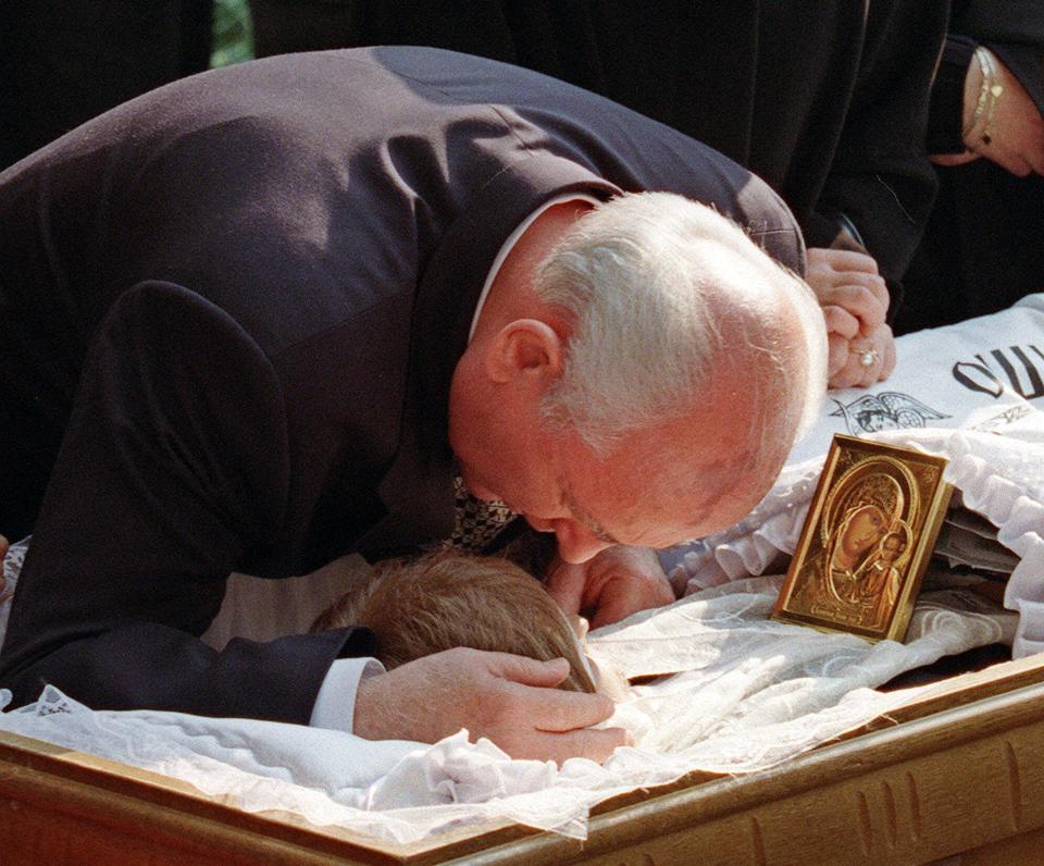 FILE - Former Soviet President Mikhail Gorbachev bids a final farewell to his wife Raisa just minutes before she was buried at Moscow's Novodevichy Cemetery in Moscow, Thursday, Sept. 23, 1999. When Mikhail Gorbachev is buried Saturday at Moscow's Novodevichy Cemetery, he will once again be next to his wife, Raisa, with whom he shared the world stage in a visibly close and loving marriage that was unprecedented for a Soviet leader. Gorbachev's very public devotion to his family broke the stuffy mold of previous Soviet leaders, just as his openness to political reform did. (AP Photo/Misha Japaridze, File)