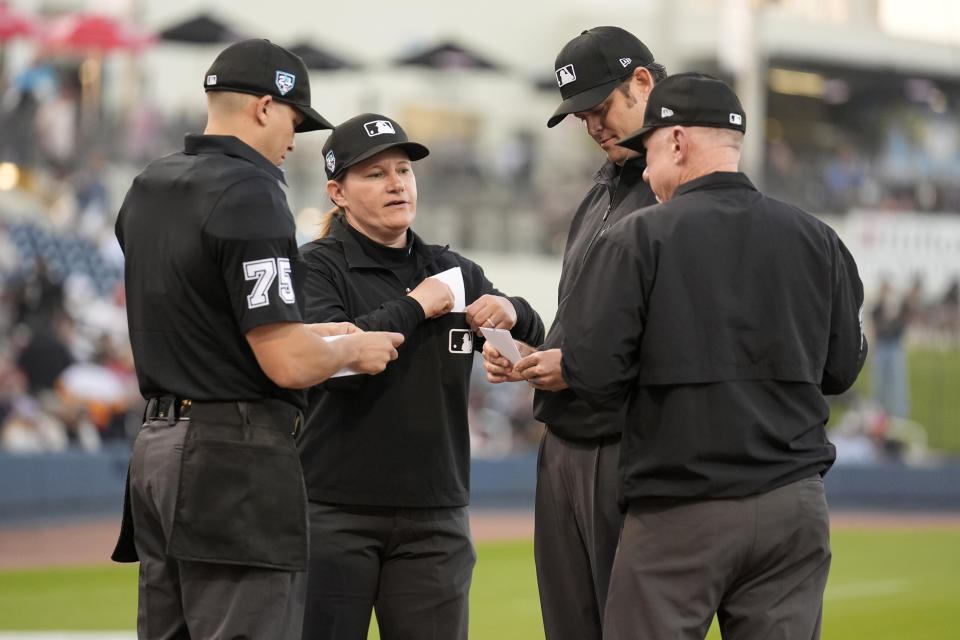 Umpire Jen Pawol, second from left, stands with fellow umpires Edwin Jimenez (75), Ryan Additon and Lance Barksdale, right, just prior to the start of a spring training baseball game between the Washington Nationals and the Houston Astros Saturday, Feb. 24, 2024, in West Palm Beach, Fla. Pawol took a big step toward breaking the gender barrier for Major League Baseball umpires when she became the first woman in 17 years to work a big league spring training game Saturday night. (AP Photo/Jeff Roberson)