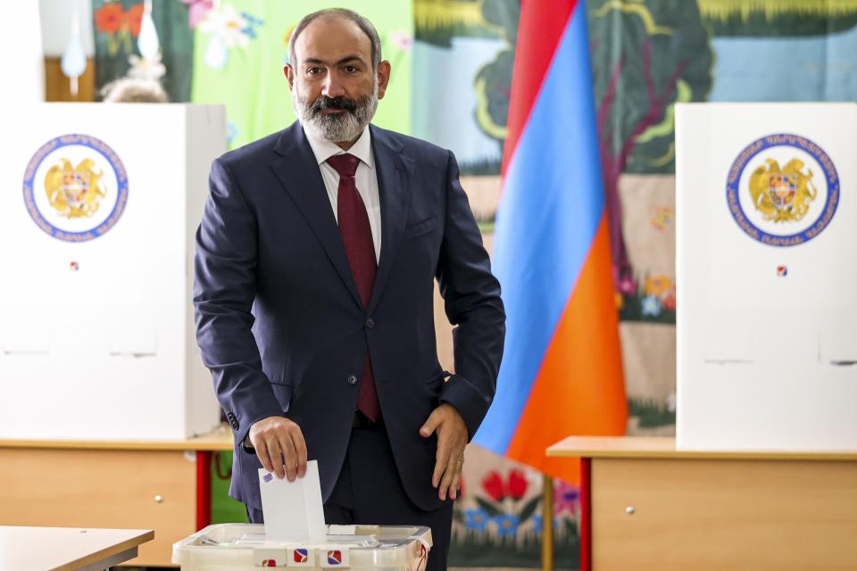 Acting Armenian Prime Minister Nikol Pashinyan casts his ballot at a polling station during parliamentary elections in Yerevan, Armenia, Sunday, June 20, 2021. Armenians are voting in a national election after months of tensions over last year's defeat in fighting against Azerbaijan over the separatist region of Nagorno-Karabakh. (Tigran Mehrabyan/PAN Photo via AP)