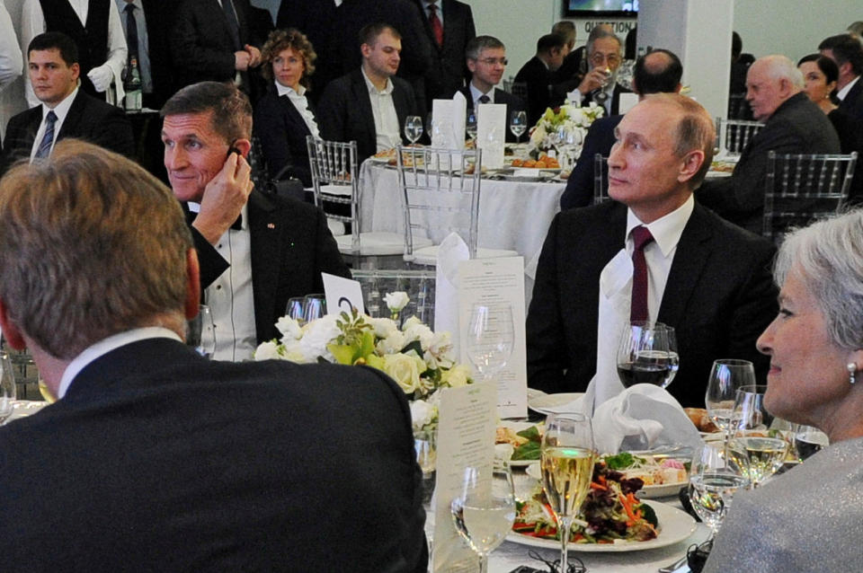 Russian President Vladimir Putin, right, sits next to retired U.S. Army Lt. Gen. Michael Flynn at an event marking the 10th anniversary of RT (Russia Today) in Moscow in 2015. (Sputnik/Mikhail Klimentyev/Kremlin via Reuters)