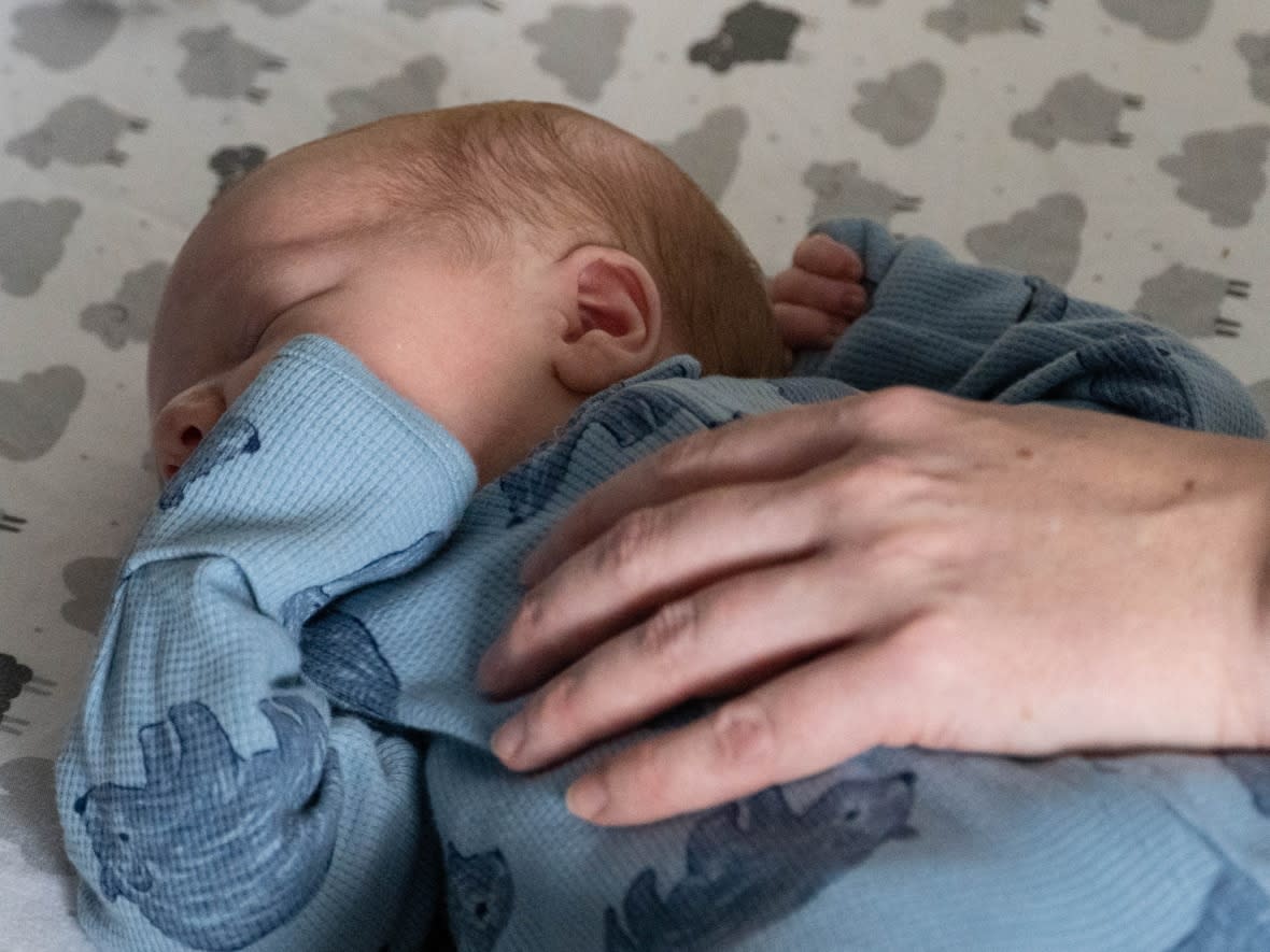 A short umbilical cord that couldn't be moved by hand was wrapped around Kayce Duval's neck when he was born, and had to be cut. His parents wonder what would have happened if they'd been driving at the time. (Jean Delisle/CBC - image credit)