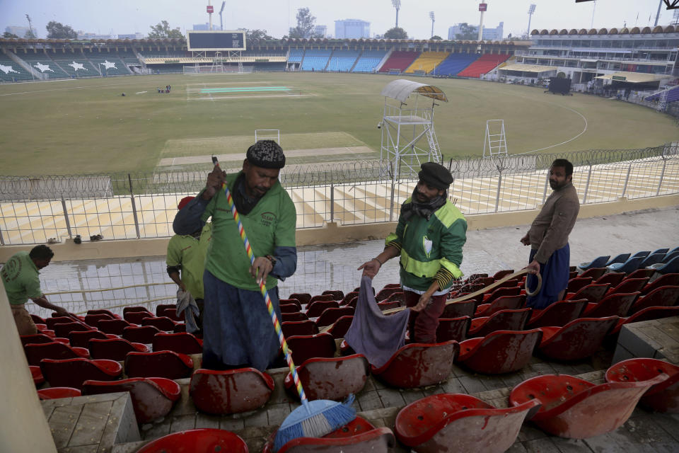 Pakistani workers clean an enclosure at Gaddafi stadium as preparation for the upcoming series against Bangladesh in Lahore, Pakistan, Tuesday, Jan. 21, 2020. Pakistan will play three Twenty20 series against Bangladesh, starting from Jan. 24, at Lahore. (AP Photo/K.M. Chaudary)