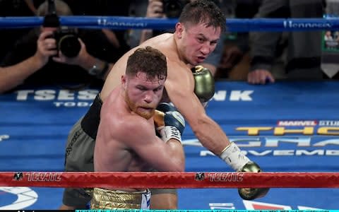 Gennady Golovkin throws a punch at Canelo Alvarez - Credit: Getty