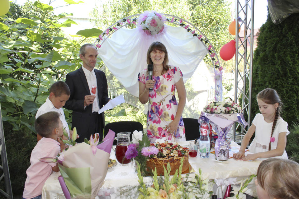 In this photo provided by Tetiana Boikiv, she, center, and Mykola "Kolia" Moroz celebrate their wedding in Ozera, Ukraine on Aug. 16, 2020. They’d met at the botanical garden in Kyiv on a church outing for singles. Boikiv moved to the village of Ozera just months before Russia’s invasion to build a new life with Kolia. (Courtesy Tetiana Boikiv via AP)