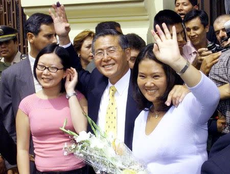 FILE PHOTO: Peruvian President Alberto Fujimori (C) and his daughters Sachi (L) and Keiko wave to supporters outside the voting station where he cast his ballot in national elections held April 9. 2000, in Lima, Peru, REUTERS/Rickey Rogers /File Photo