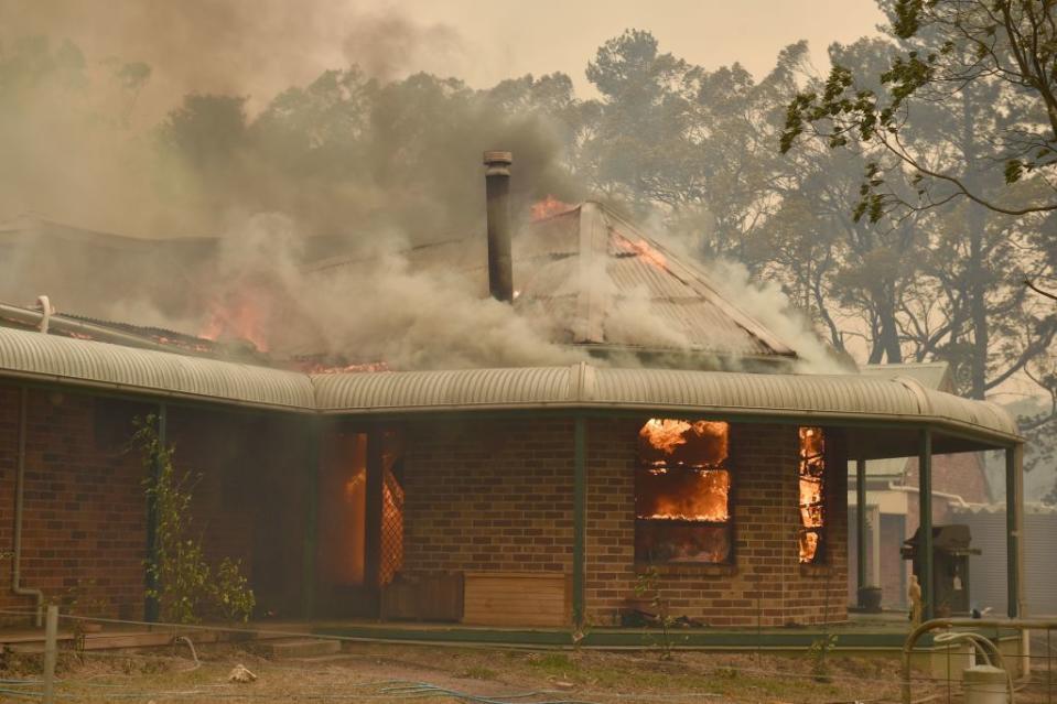 Fire is seen through the glass windows of a home in Balmoral, where a bushfire all but destroyed the town. 