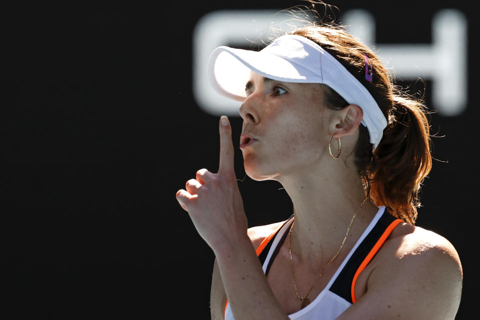 Alize Cornet of France gestures during her fourth round match against Simona Halep of Romania at the Australian Open tennis championships in Melbourne, Australia, Monday, Jan. 24, 2022. (AP Photo/Tertius Pickard)