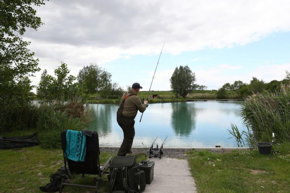 An angler casts off at Acorn Fisheries in Kingston Seymour, SomersetGetty