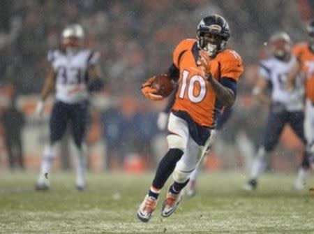 Denver Broncos wide receiver Emmanuel Sanders (10) carries the ball following a reception in the fourth quarter against the New England Patriots at Sports Authority Field at Mile High. Mandatory Credit: Ron Chenoy-USA TODAY Sports