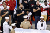 FILE - In this Sept. 1, 2016, file photo, San Francisco 49ers quarterback Colin Kaepernick, middle, kneels during the national anthem before an NFL preseason football game against the San Diego Chargers in San Diego. Kaepernick was a second-round draft pick in 2011 who the next year led the San Francisco 49ers to the Super Bowl. By 2016, he had begun kneeling on the sideline at games during the national anthem to protest social injustice and police brutality. Soon after, he was gone from the NFL, and he has not played since. (AP Photo/Chris Carlson, File)