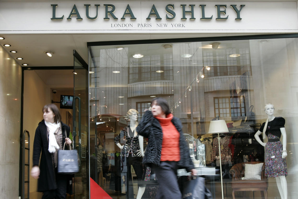 Pedestrians walk past a Laura Ashley store in London's Kensington High Street, Tuesday, Feb. 17, 2009. Shares in Laura Ashley Holdings PLC fell Tuesday after the company warned of lower than expected profits for the year ending Jan. 31, due to the recession in Britain, the falling value of the pound and higher spending on promotions. (AP Photo/ Alastair Grant)