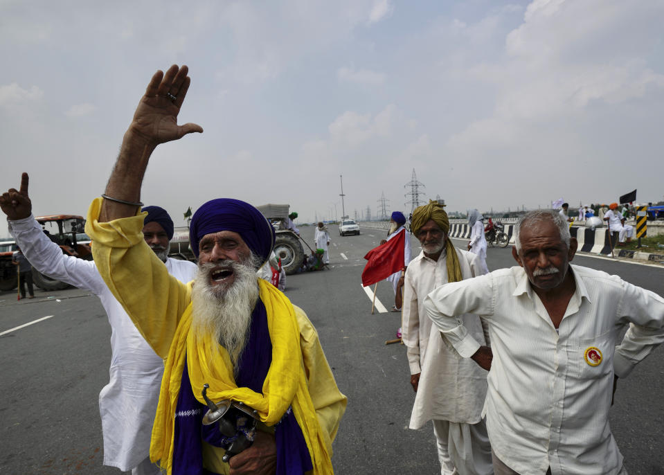 Protesting farmers gather at Singhu, outskirts of New Delhi, India, Monday, Sept.27, 2021. Thousands of Indian farmers Monday blocked traffic on major roads and railway tracks outside of the nation's capital, calling on the government to rescind agricultural laws that they say will shatter their livelihoods. The farmers called for a nation-wide strike to mark one year since the legislation was passed, marking a return to protests that began over a year ago. (AP Photo/Manish Swarup)