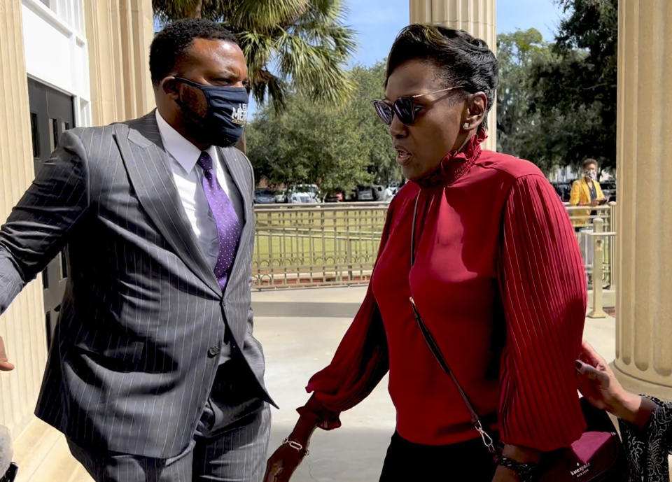 Ahmaud Arbery's mother Wanda Cooper-Jones heads into the Glynn County Courthouse in Brunswick, Ga while her attorney attorney Lee Meritt on Monday, Oct. 18, 2021. Jury selection got underway with hundreds of people ordered to report for what could be a long, laborious effort to find jurors to hear the trial of three white men charged with fatally shooting Ahmaud Arbery as he was running in their neighborhood. (AP Photo/Lewis M. Levine)