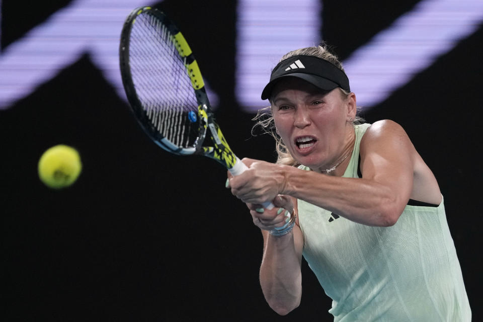 Caroline Wozniacki of Denmark plays a backhand return to Maria Timofeeva of Russia during their second round match at the Australian Open tennis championships at Melbourne Park, Melbourne, Australia, Wednesday, Jan. 17, 2024. (AP Photo/Louise Delmotte)