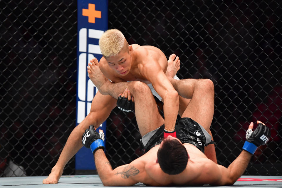 Feb 17, 2024; Anaheim, California, USA; Rinya Nakamura pins Carlos Vera to the mat during UFC 298 at Honda Center. Mandatory Credit: Gary A. Vasquez-USA TODAY Sports